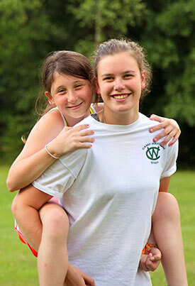 Camp Watitoh summer camp counselor with new camper